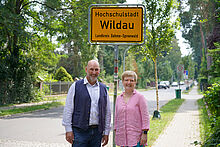 Hochschulstadt Wildau Wildaus Bürgermeister Frank Nerlich und TH-Wildau-Präsidentin Prof. Ulrike Tippe vor einem Ortseingangsschild der Hochschulstadt Wildau