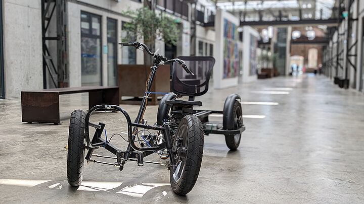 Vierrädriges Fahrrad im Gang einer Werkshalle, die neu restauriert wurde
