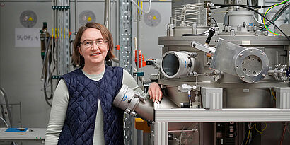 Frau steht in einem Labor der Physikalischen Technologien