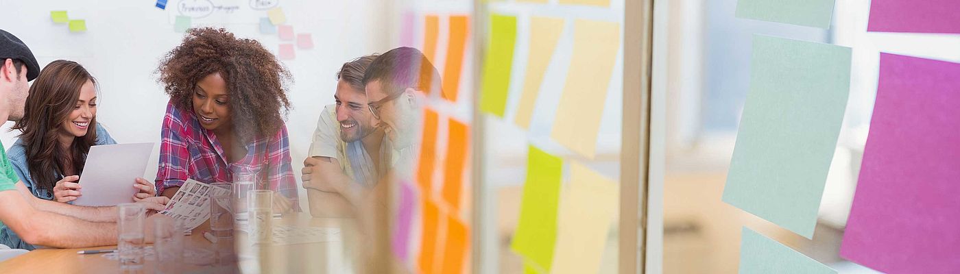 Millennial creative team around table and sticky note transition