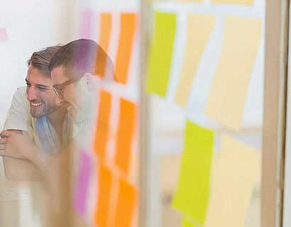 Millennial creative team around table and sticky note transition