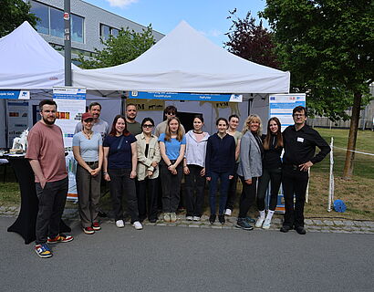 Gruppe von mehreren Personen steht zusammen für ein Foto