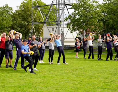 Menschen beim Ballspiel auf einer Wiese