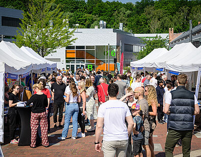 Besucherinnen und Besucher des HIT 2024 der TH Wildau zwischen den Pagoden auf dem Campus.