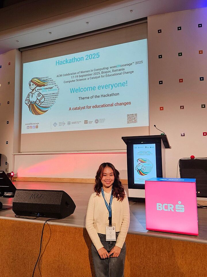 Studentin Rachel Mah steht vor einer Projektionsfläche zum Hackathon